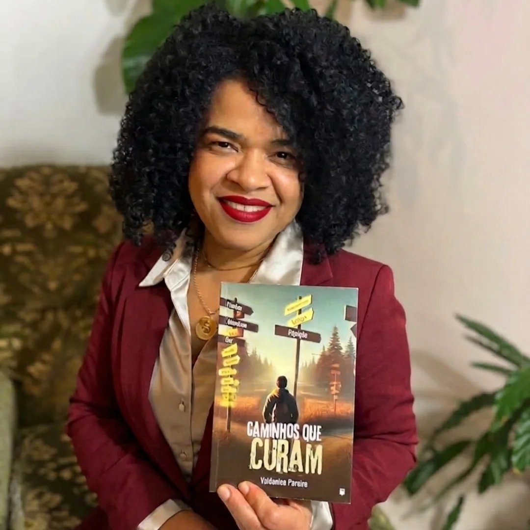 Valdenice Pereira segurando o livro Caminhos que Curam